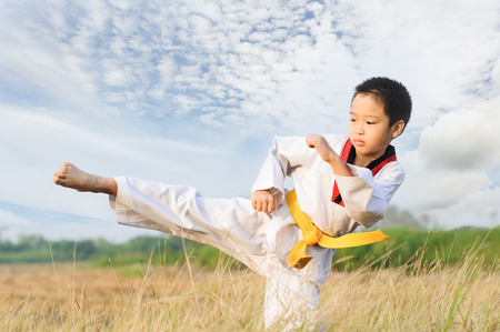 Asian boy practice taekwondo on the fieldの写真素材