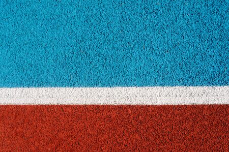 Running track made from red and blue granule rubber split by white line
