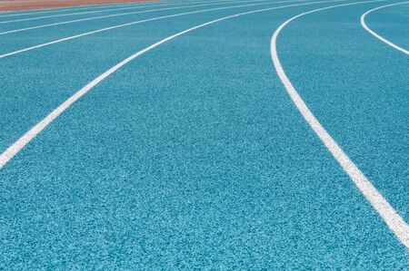 Blue running track with white split lineの写真素材