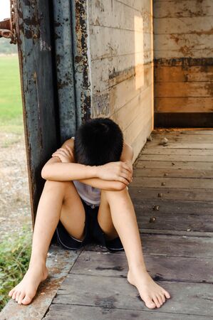 The lonely boy the old train room looking to outsideの写真素材