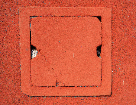 Square Drain water gate on red granule rubberの写真素材