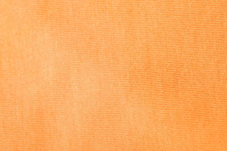 Close up flat orange fabric textile backgroundの写真素材