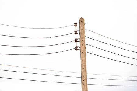 Old concrete electricity pylon in the on white sky