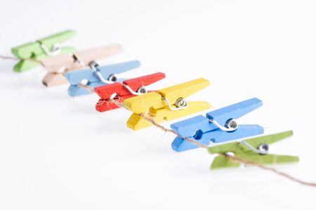 Several color of wood clip on rope on white backgroundの写真素材
