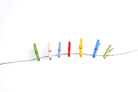 Several color of wood clip on rope on white background