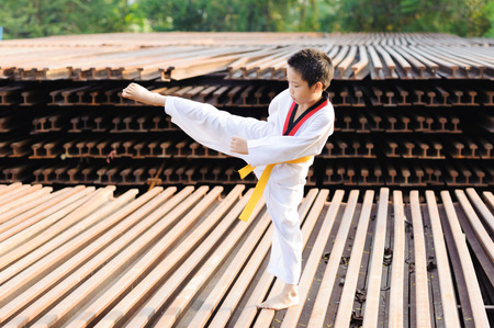 Asian boy practice taekwondo at the construction areaの写真素材