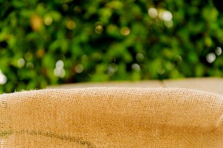 Thin focus old brown ramie sac with green leaf backgroundの写真素材