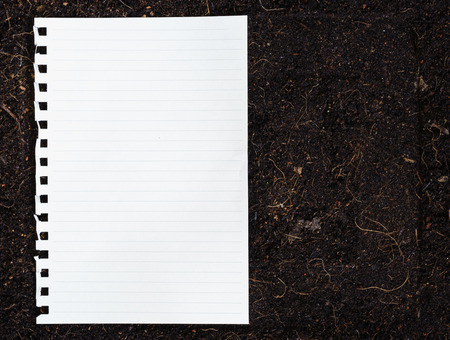 The old page ripped off from the notebook on soil backgroundの写真素材