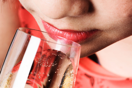 Close up thin focus on red lip Asian young woman drinking champagneの写真素材