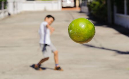 Close up citrus from boy trow away under the day lightの写真素材