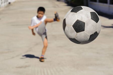 Close up Ball fly from the boy kick
