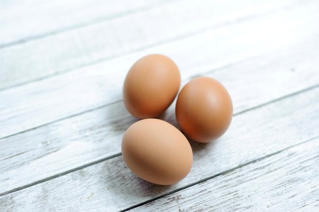 Three egg on old grunge wood tableの写真素材