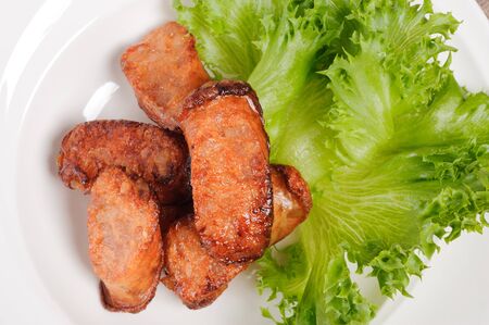 Thai food deep fry fish sausage with vegetable on white dish on wood table