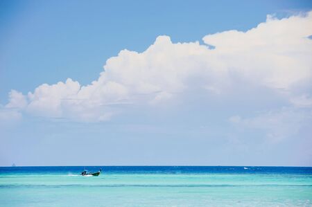 Boat on the sea on blue sky white cloud