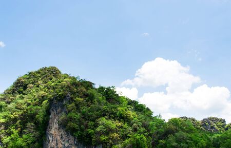 Mountain forest and sea water on White cloud on blue sky in summer dayの写真素材