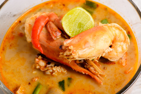 Tom Yum Goong - Famous and very delicious food that hot and spicy soup with shrimp that could easily found in most of resturant in Thailand, serve in glass bowl. Thai Cuisineの写真素材