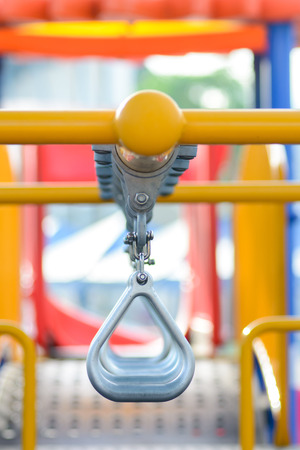 Swinging and climbing metal bar at kids playgroundの写真素材