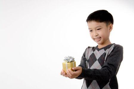 Young boy carry gift box in his hand. Christmas and new year concept.の写真素材