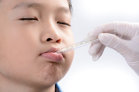 Young asian boy has measuring by termomether at hospital. Heath concept