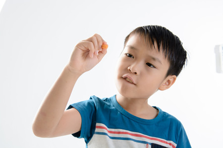 Young asian boy writing in the air