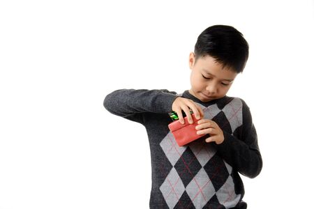 Young boy open gift box in his hand. Christmas and new year concept.