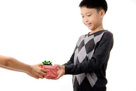 Young boy carry gift box in his hand. Christmas and new year concept.の写真素材