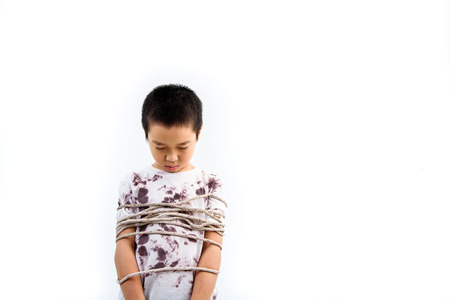 Boy got rope around his body fell unhappy.の写真素材