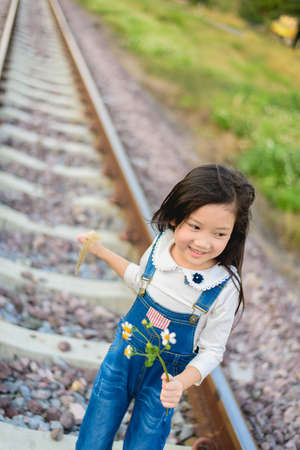 Selective focus on Asian young beautiful girl walking on the railway.の写真素材