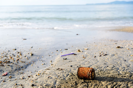 Many piece of garbage on the sand beace near the seaの写真素材