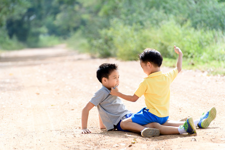 Two boy angry and figthing by punch on the other on the urban road during summer time..の写真素材