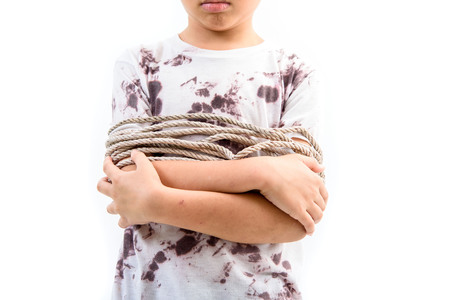 Boy got rope around his body fell unhappy.の写真素材