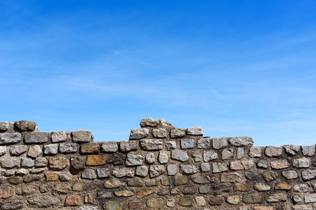 Old stone wall background under blue sky day.の写真素材