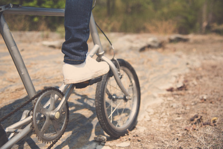 Vintage color, Selective focus at leg and shoe of Young boy wear blue jean riding vintage color old...