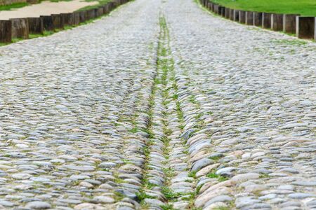 Selective focus on a part of antique stone road and some of little glass.の写真素材