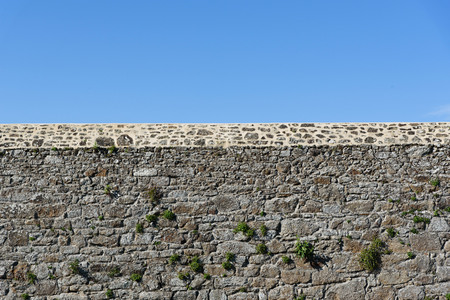 Old stone wall and blue sky in the day time.の写真素材