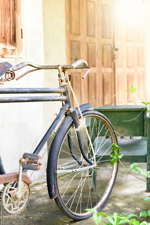 Warm tone, Selective focus at old and rusty vintage bicycle park at the old wallの写真素材