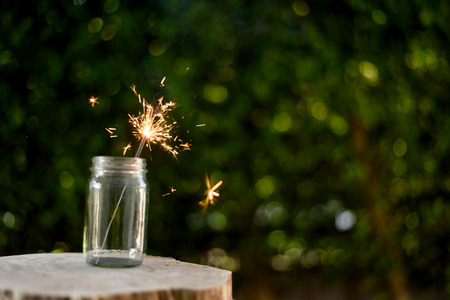 Beautiful little candle fireworks in glass bottle.の写真素材