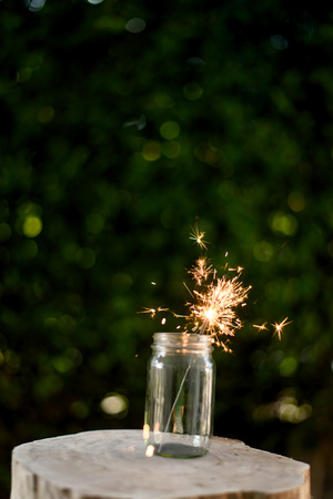 Beautiful little candle fireworks in glass bottle.の写真素材