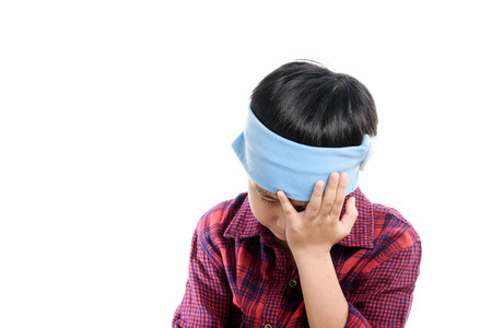 Young Thai boy headach by an illness and use ice cube to decrease temperature.の写真素材