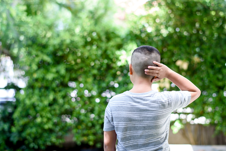 Young asian boy feel comfortable with short hair cut in a gardenの写真素材