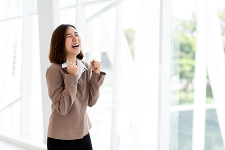 Young Asian happy woman stand in an officeの写真素材
