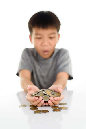 Selective focus at coin in child hand.の写真素材