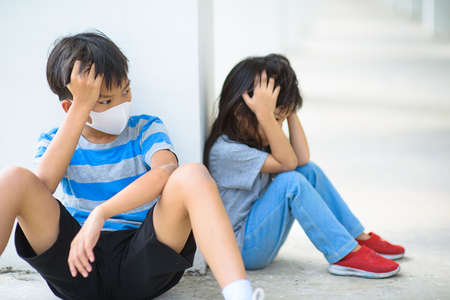 Young boy and girl wearing a mask and feel uncomfortable from sick.