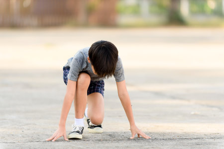 Young Asian boy running in summerの写真素材