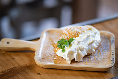 Selective focus, beautiful croissant with cream prepare on a wooden plateの写真素材