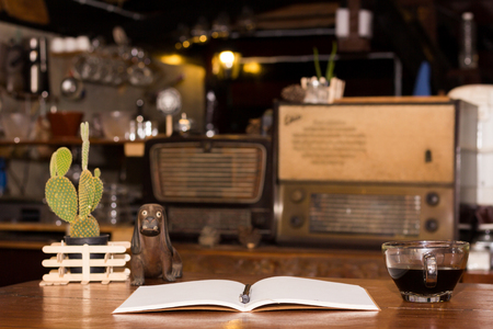Black coffee cup and wooden desk diaryの写真素材