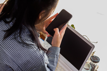 businesswomen using cellphone working in coffee shop.The concept of remote work business lady.