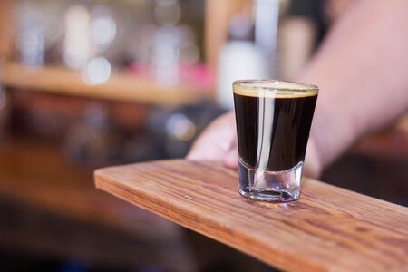 Woman holding cup of coffee in the coffee shop.の写真素材