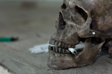 Human skull smoking a cigarette,Dead because of smoking,Stop Smoking Concept.の写真素材