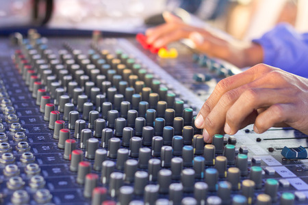 hand adjusting volume sound of mixer, sound and music concept